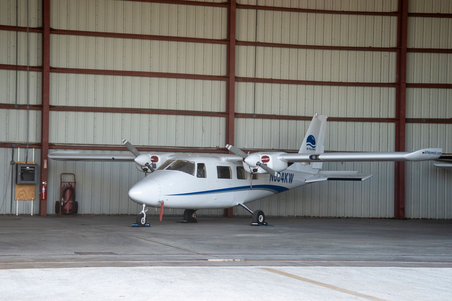 Small private airplane parked inside an aircraft hangar in Florida